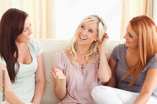 Photo: Joyful friends sitting on a sofa Joyful friends sitting on a sofa