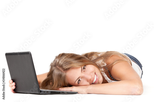 Photo: Woman with laptop lying down on the floor Woman with laptop lying down on the floor