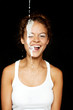 Portrait of a beautiful girl with face splashed with milk