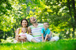 happy young couple with their children have fun at park happy young couple with their children have fun at park