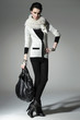 ,fashion model in autumn/winter clothes holding handbag posing