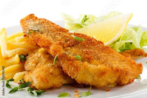 Photo: Fish dish - fried fish fillet, French fries with vegetables Fish dish - fried fish fillet, French fries with vegetables
