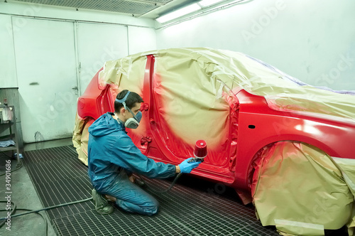 Photo: Painting a red car. Painting a red car.