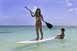 young couple with their paddle board in hawaii young couple with their paddle board in hawaii