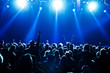 concert crowd in front of bright blue stage lights
