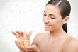 beauty putting cream, water drops on background