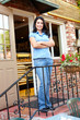 Woman standing outside bakery/café