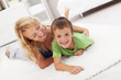 Happy mother and son playing in the living room