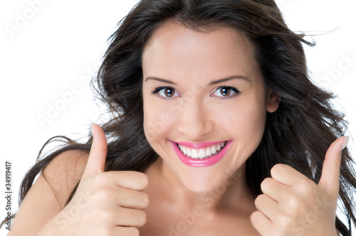 Photo: Young woman shows two thumbs Young woman shows two thumbs