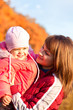 Happy mother with daughter enjoying a autumn day