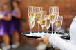 Waiter serving champagne at festive event