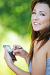 young smiling brunette woman holding smartphone and stylus