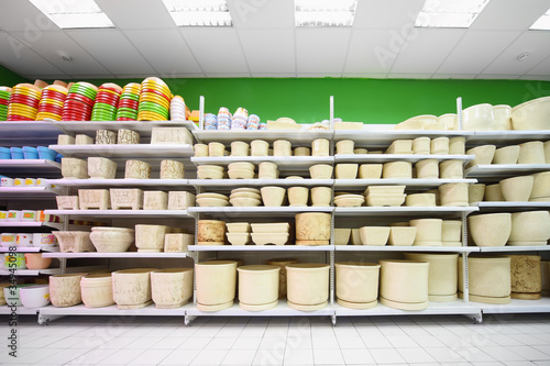Photo: Shelves with variety of beige and colorful clay flowerpot Shelves with variety of beige and colorful clay flowerpot