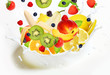 Lot of different fruits falling into milk Lot of different fruits falling into milk