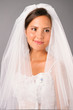 beautiful bride under a veil on studio neutral background