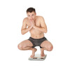 squats on scale young man in panties