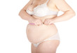overweight woman in  underwear measuring her stomach