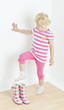 little girl putting on rubber boots little girl putting on rubber boots