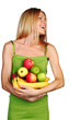 woman holds a pile of fruit
