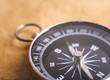 Close-up view of compass isolated on old paer background Close-up view of compass isolated on old paer background