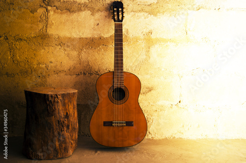 Photo: Acoustic guitar on old wall - copyspace Acoustic guitar on old wall - copyspace