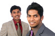 Two Indian business people posing to the camera,