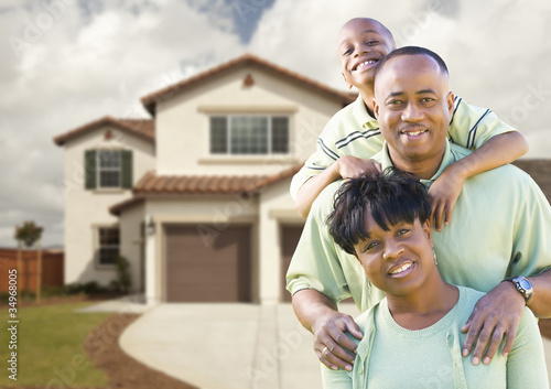 Photo: Attractive African American Family in Front of Home Attractive African American Family in Front of Home