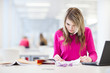 Photo: in the library - pretty, female student with laptop in the library - pretty, female student with laptop