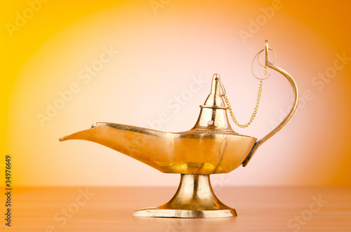Photo: Ancient lamp against gradient background Ancient lamp against gradient background