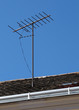 Television antenna on the roof over blue sky