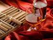 cuban cigar and bottle of liquor over red satin cuban cigar and bottle of liquor over red satin