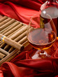 cuban cigar and bottle of liquor over red satin cuban cigar and bottle of liquor over red satin