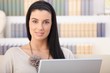 Smiling woman with laptop at home