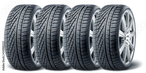 Foto: Set of winter tires with alurim on white background Set of winter tires with alurim on white background
