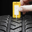 Close up of checking the tread pattern of a winter tire