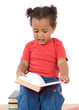 Baby reading sitting on a pile of books
