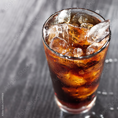 Photo: glass of cola with ice with copyspace in composition glass of cola with ice with copyspace in composition