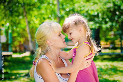 Photo: mother with a young daughter resting in a park mother with a young daughter resting in a park