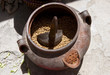 Clay pot with barley and wooden ladle, Tibet