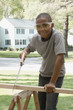 African boy sawing wood