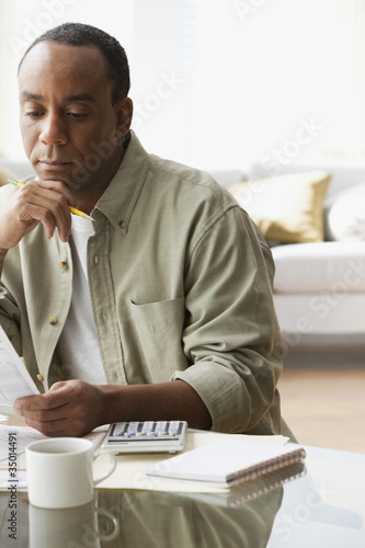 Photo: African man paying bills African man paying bills