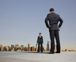 Business people standing on urban rooftop