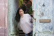 Hispanic woman opening door