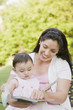 Hispanic mother reading to daughter
