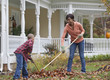 Black mother and son raking leaves