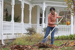 Black woman raking leaves