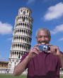 African American man standing near Leaning Tower of Pisa