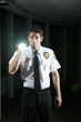 Hispanic security guard checking dark offices