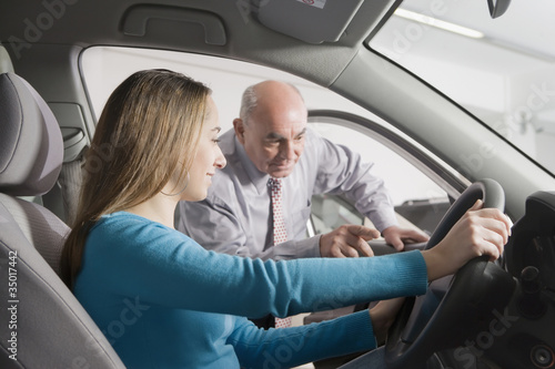 Photo: Hispanic woman shopping for new car Hispanic woman shopping for new car