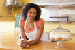 African American business owner leaning on cafe counter